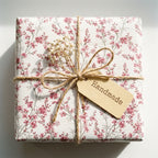 Vintage pink floral wrapping paper by Wrapped Studios, rustic gift wrap tied with twine and a handmade tag.