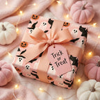 Cute pink Halloween wrapping paper with ghosts and pumpkins on a cozy gift box, by Wrapped Studios.
