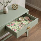 Pink rose floral wrapping paper used as a luxury drawer liner in a sage green table, by Wrapped Studios.