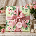 Luxury floral wrapping paper with pink roses and a satin bow, by Wrapped Studios.