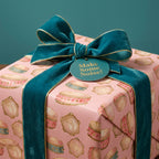 Whimsical pink drum wrapping paper with luxury teal velvet ribbon, birthday gift wrap by Wrapped Studios.