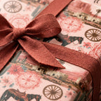 Pink western wrapping paper with desert scene and rustic terracotta ribbon by Wrapped Studios.