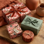 Pink western wrapping paper with desert horse print on rustic gift boxes by Wrapped Studios.