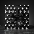 Quirky black and white monkey wrapping paper with a black bow, by Wrapped Studios.
