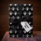 Black monkey wrapping paper with a Game On gamer tag and sheer ribbon by Wrapped Studios.