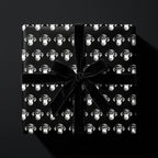 Luxury black and white monkey wrapping paper with a velvet bow on a gift box by Wrapped Studios.