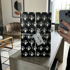 Quirky black and white monkey wrapping paper with a silver bow and tag by Wrapped Studios.