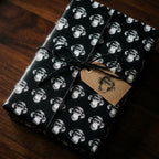 Quirky monkey wrapping paper in black and white on a gift box with a kraft tag, by Wrapped Studios.