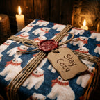 Polar bear Christmas wrapping paper with rustic twine and "Stay Cozy" tag by Wrapped Studios.