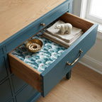 Polar bear wrapping paper used as a drawer liner in a cozy blue dresser drawer by Wrapped Studios.