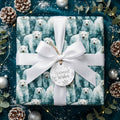 Polar bear Christmas wrapping paper by Wrapped Studios, tied with a white ribbon and a Warmest Wishes tag.