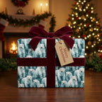 Polar bear Christmas wrapping paper with red velvet bow by Wrapped Studios, in front of a Christmas tree.