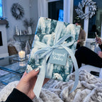 Watercolor polar bear Christmas wrapping paper with blue ribbon by Wrapped Studios.