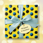 Square gift wrapped in playful yellow polka dot wrapping paper with a light blue satin ribbon.