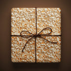 Novelty gift wrap with a fun popcorn print and a brown twine bow on a square box.