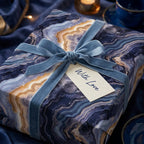 Luxury blue and gold agate wrapping paper with a velvet bow by Wrapped Studios.