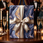 Luxury blue and gold geode wrapping paper with champagne satin bow by Wrapped Studios.
