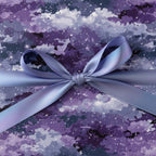 Modern galaxy wrapping paper with a periwinkle satin ribbon tied in a bow.