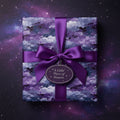 Square gift wrapped in modern purple galaxy wrapping paper with satin ribbon bow against a starry background.