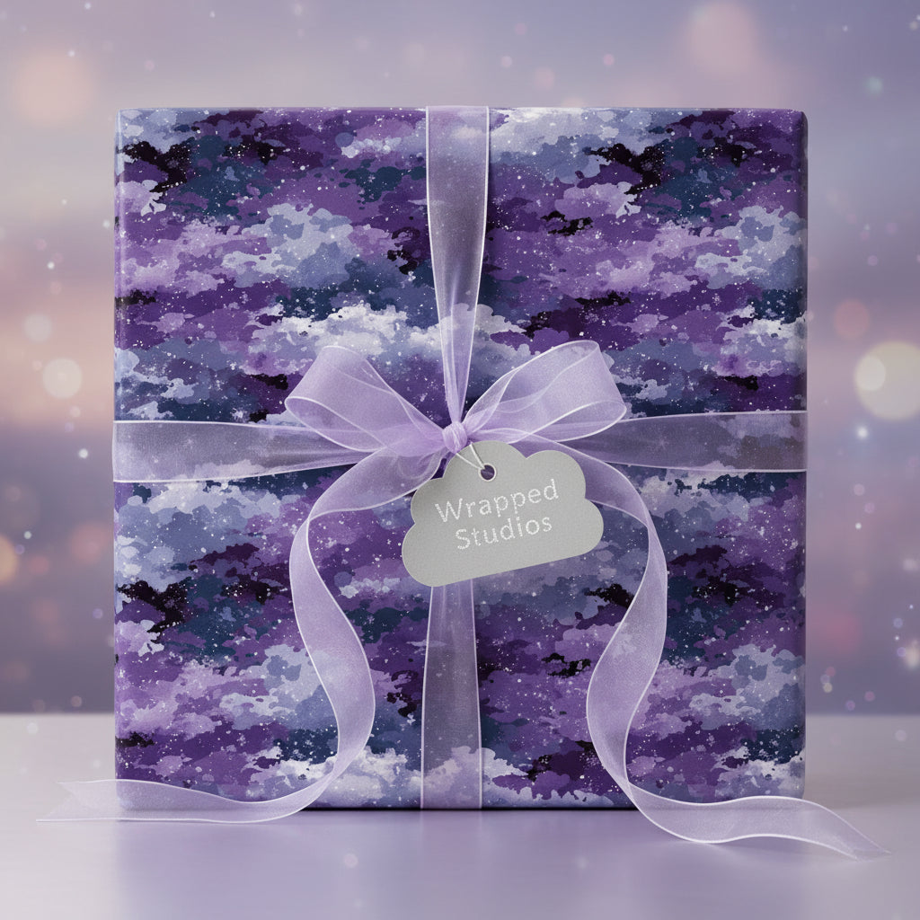 Square gift wrapped in purple galaxy-themed wrapping paper with sheer lavender ribbon.