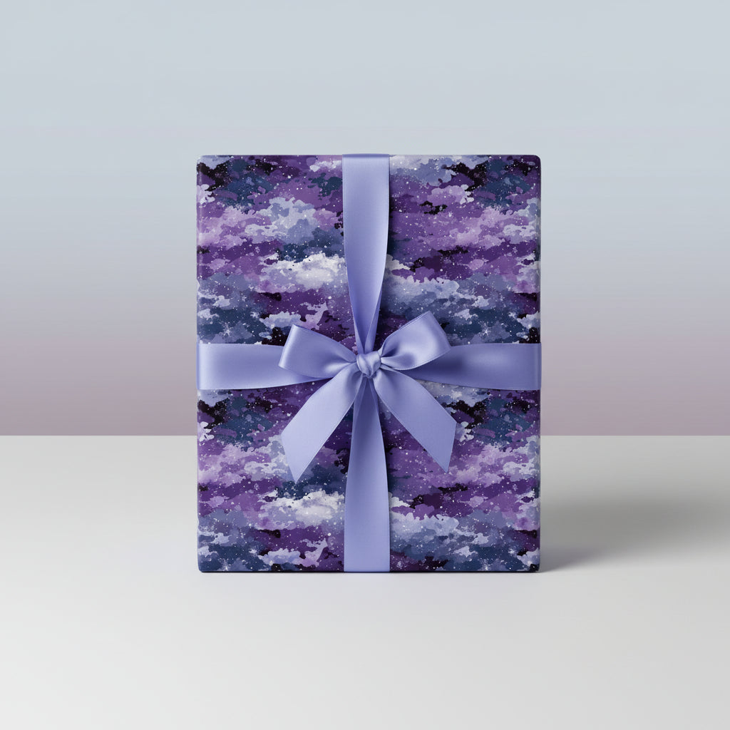 Purple and navy gift box wrapped in celestial watercolor pattern wrapping paper with matching ribbon.