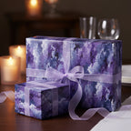 Elegant gifts wrapped in purple watercolor-style wrapping paper with sheer ribbon bows.