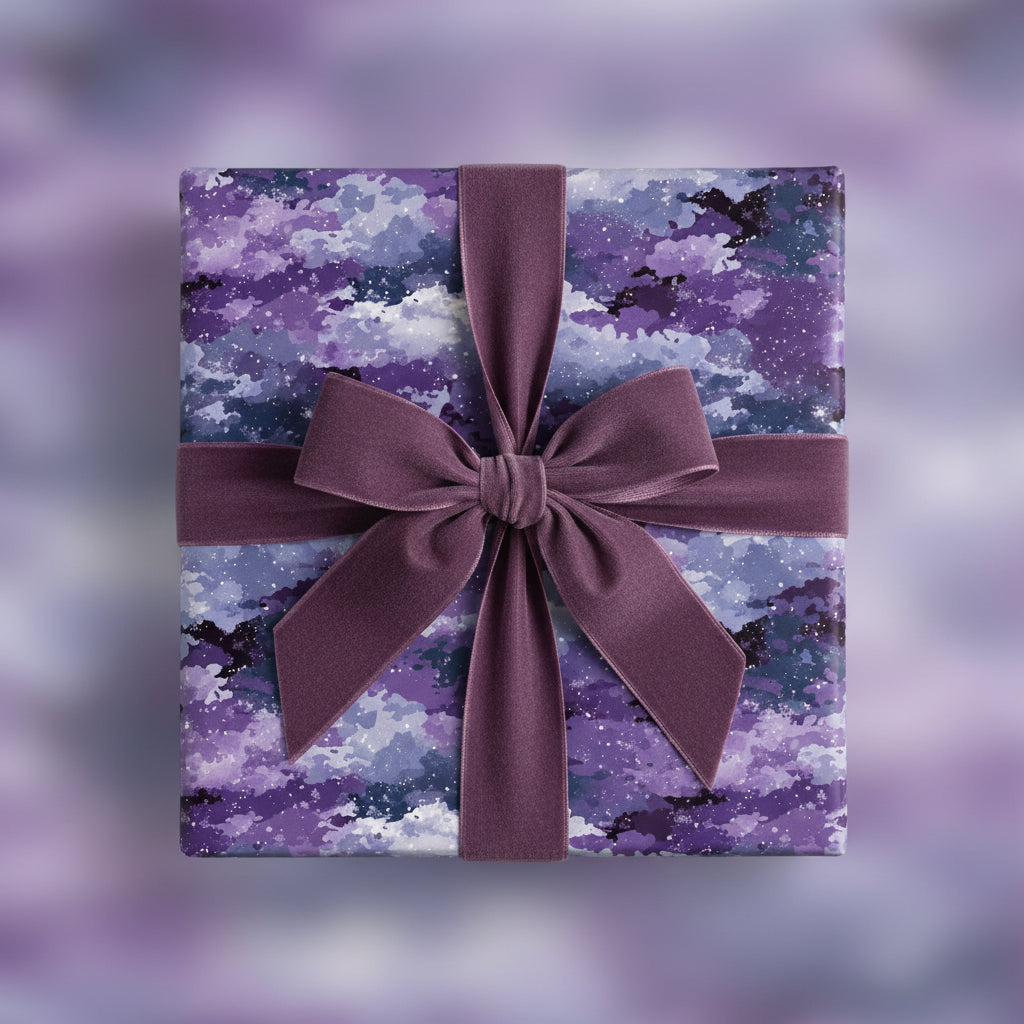 Elegant gift wrapped in purple watercolor wrapping paper with a velvet bow.