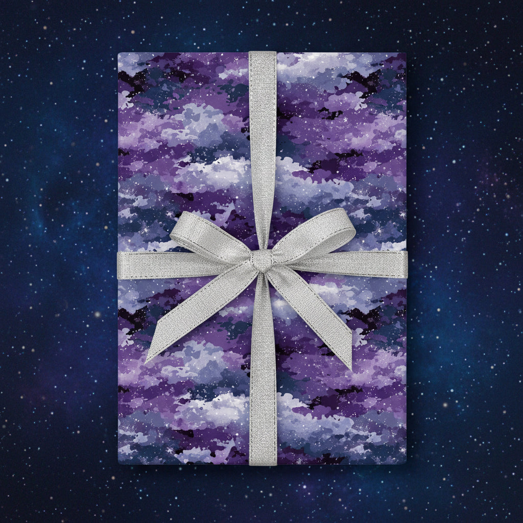 Gift wrapped in purple galaxy wrapping paper with a silver ribbon.