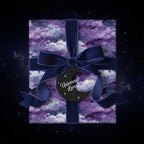 Square gift wrapped in purple galaxy wrapping paper with velvet ribbon and "Universal Love" tag.