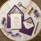 Elegant purple and gold marble wedding invitation suite with silk ribbon by Wrapped Studios.