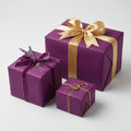 Elegant purple gift boxes wrapped in satin gold, velvet plum, and gold string with a wax seal.