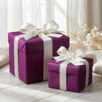 Elegant plum gift boxes wrapped with white satin ribbon, perfect for birthday or wedding presents.