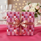 Red and pink patchwork pattern wrapping paper with a rose gold ribbon bow, perfect for elegant birthday or anniversary gifts.