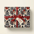 Cute raccoon Christmas wrapping paper with a red bow and tag by Wrapped Studios.