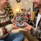 Raccoon Christmas wrapping paper by Wrapped Studios on a holiday gift exchanged by a cozy couple.