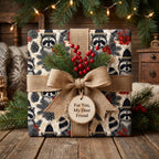 Raccoon Christmas wrapping paper with a rustic burlap bow on a holiday gift box by Wrapped Studios.