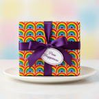 Rainbow wrapping paper gift box with purple ribbon and "Pure Happiness" tag.