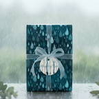 Teal raindrop wrapping paper with sheer ribbon bow and a "Whispers of Rain" gift tag.