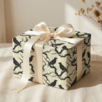 Gift box in crow print wrapping paper with cream ribbon, perfect for Halloween or gothic gift wrap.