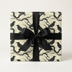 Chic black raven print wrapping paper with matte black ribbon; spooky luxury gift wrap for Halloween or gothic occasions.