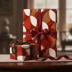 Gifts wrapped in modern geometric wrapping paper with a burgundy satin ribbon.