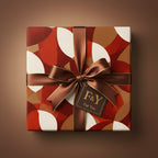 Square gift box wrapped in modern geometric print paper with a brown ribbon and "For You" tag.