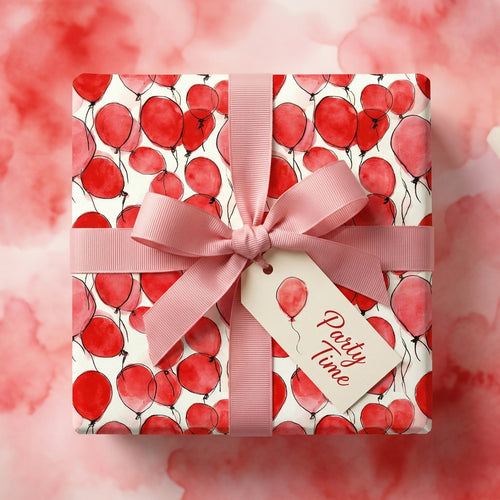 Red balloon pattern wrapping paper with pink ribbon for birthday party gift, by Wrapped Studios.
