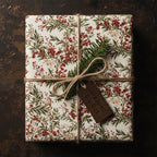 Christmas gift wrapped in elegant floral wrapping paper with red berries and twine bow.