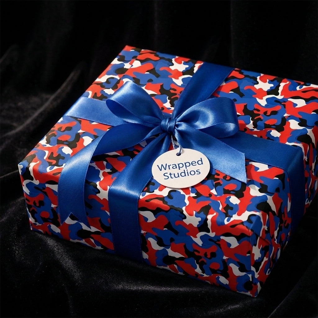 Red and blue camouflage wrapping paper with a blue satin bow by Wrapped Studios.