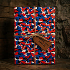 Red and blue camo wrapping paper with an adventure gift tag and twine bow by Wrapped Studios.