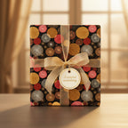 Elegant birthday wrapping paper with gold ribbon and dark background, abstract circle pattern.