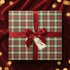 Wrapped present in plaid Christmas gift wrap with a red ribbon and "Seasons Greetings" tag.