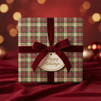 Square gift wrapped in plaid Christmas wrapping paper with velvet burgundy ribbon and "Happy Holidays" tag.