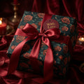 Elegant gift wrapped in floral rose wrapping paper with a red satin ribbon and "With Love" tag.